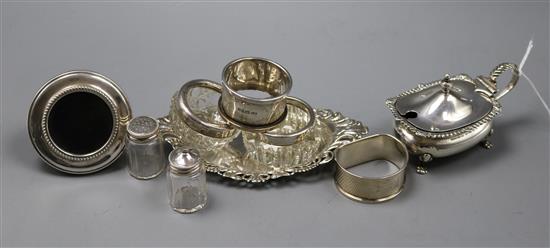 A silver mustard pot, silver bonbon dish, two silver napkin rings and five other items.